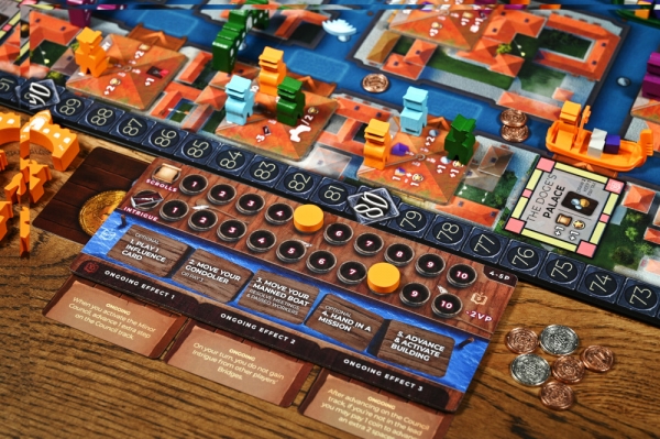A view of a player board with the scrolls and intrigue tracks. Note that the metal coins are an upgrade, not standard.